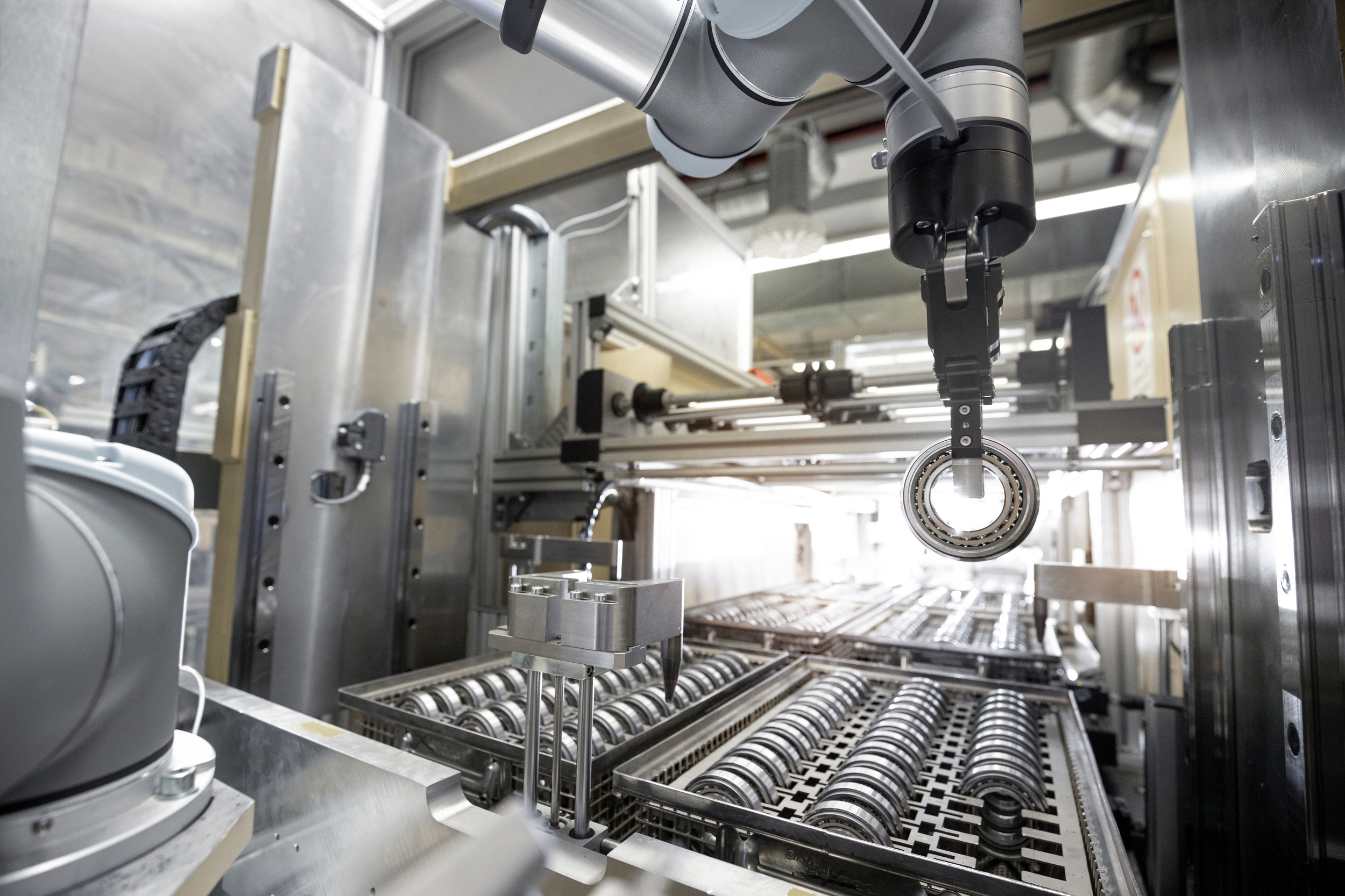The picture shows an automated tray assembly with roller bearings because this is a glossary of bearing terms.